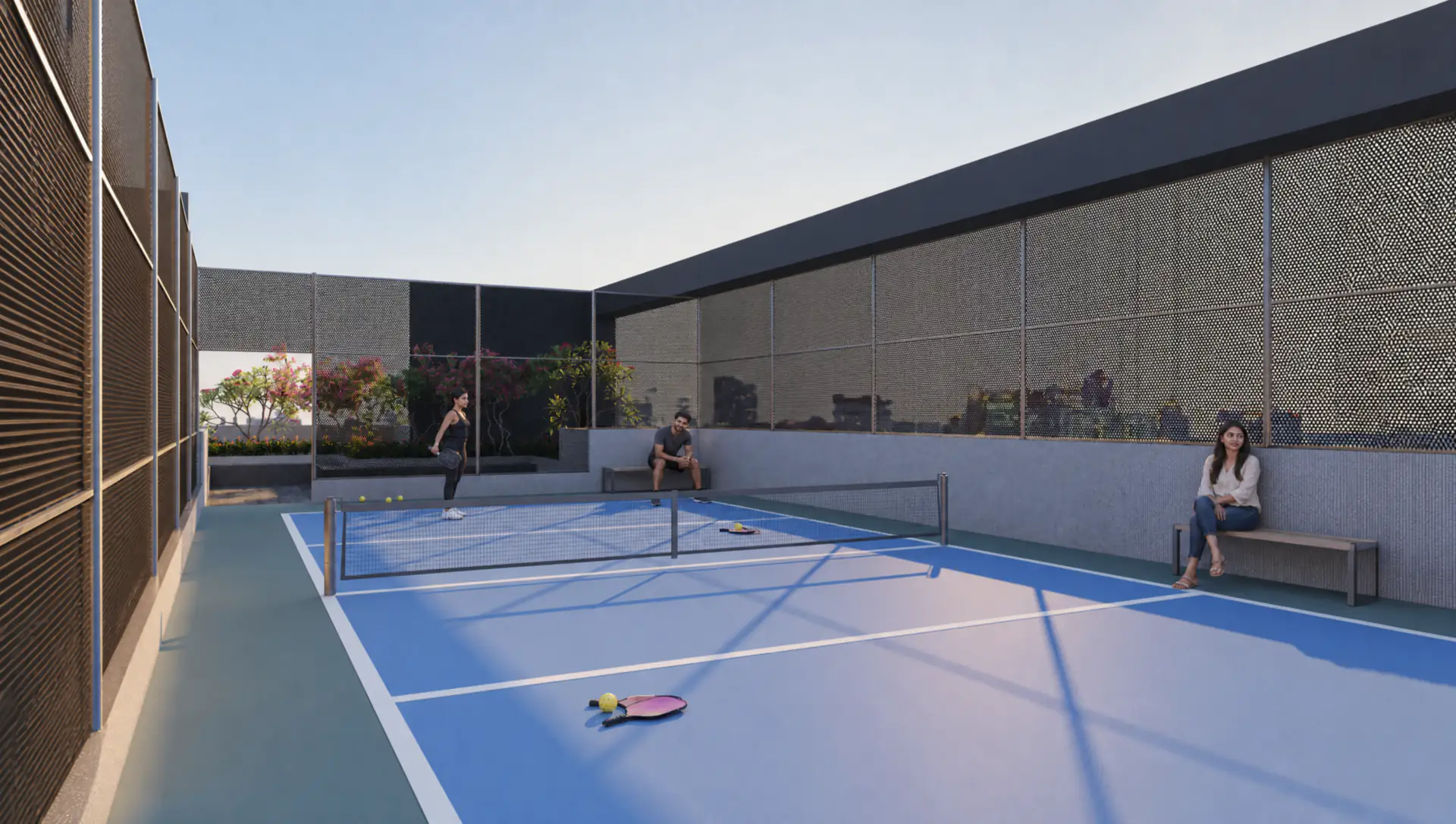 The rooftop pickleball court at Sun Garnet, with players on the court and a spectator on the bench